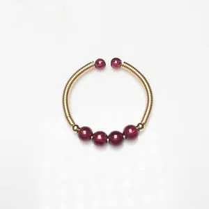Handmade 14K gold wire wrapped ring with garnet beads in a minimalist open design