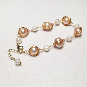 Macro shot of 14K gold-filled wire wrapped pink pearls with adjustable lobster clasp