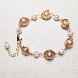 Macro detail of handmade 14K gold-filled wire wrapped freshwater pearl bracelet with lobster clasp