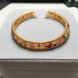 Detail of 14K gold filled wire wrapped tourmaline bracelet with freshwater pearl accents