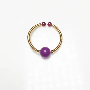 Detailed view of handmade 14K wire-wrapped ring with purple and reddish brown beads
