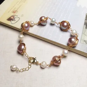 Detailed macro view of 14K gold wrapped lavender pearls with handmade wire weaving craft
