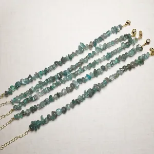 Close-up of five handmade natural gemstone chip bracelets with gold lobster clasps