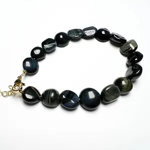 Macro detail of natural blue tiger eye stone beads with 14K gold lobster clasp and chain