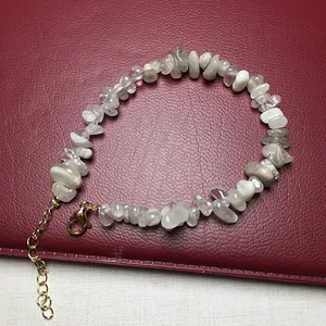 Macro detail of natural irregular crystal chips bracelet with gold lobster clasp