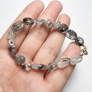 Detailed shot of black rutilated quartz bracelet with 14K gold-filled lobster clasp