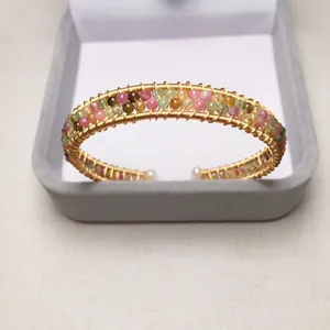 Detail of handmade 14K gold-filled tourmaline wrap bracelet with white pearl endings