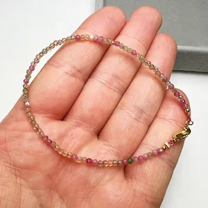 Detailed view of candy colored 2.4mm faceted tourmaline bead bracelet with gold clasp