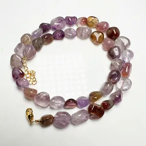 Detailed macro view of multi-color polished crystal shards on adjustable gold necklace