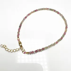 Close-up of 2.4mm candy-colored tourmaline beaded anklet with golden lobster clasp and chain