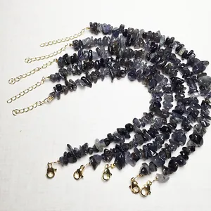 Close-up of deep purple crystal chip bracelets with gold lobster clasp and chain