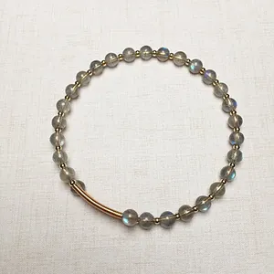 Vue détaillée du bracelet en perles de labradorite gris foncé avec accents dorés 14 carats