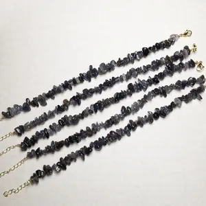 Detailed view of 5 natural stone bracelets with golden lobster clasps and adjusters