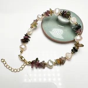 Detail of baroque pearl bracelet with colorful tourmaline chips and golden lobster clasp
