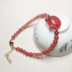 Translucent strawberry quartz beaded bracelet with pink carved cat head and gold clasp