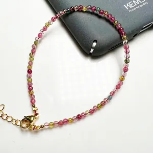 Détail du bracelet en perles de tourmaline colorées avec fermoir mousqueton doré réglable