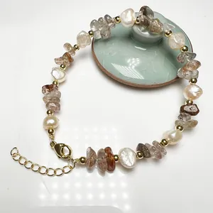Detail of baroque pearls and natural crystal stones with gold lobster clasp and extension chain