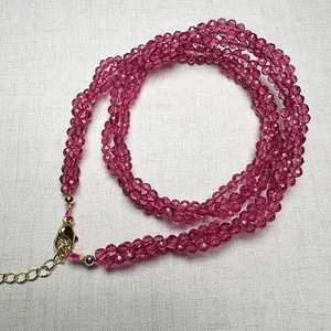 Detailed macro view of 3mm rose red spinel beaded necklace with golden lobster clasp closure