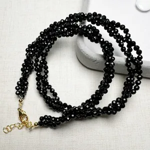Macro detail of multi-strand black faceted spinel necklace with gold-plated lobster clasp