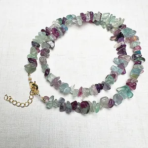 Green fluorite and colorful crystal gravel necklace with gold clasp on white background