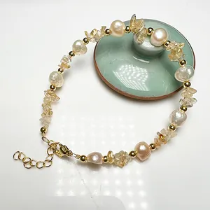 Detail of baroque freshwater pearl bracelet with citrine stones and gold clasp