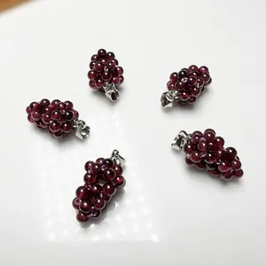 Five rose red garnet grape cluster pendants with silver clasps on white background