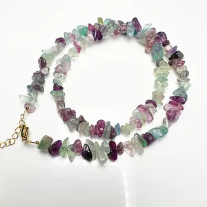 Detailed macro view of colorful fluorite gravel necklace with golden lobster clasp