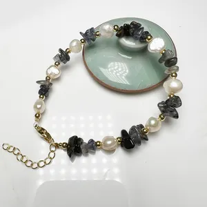 Detail of freshwater pearl bracelet with crushed tourmaline stones and golden lobster clasp