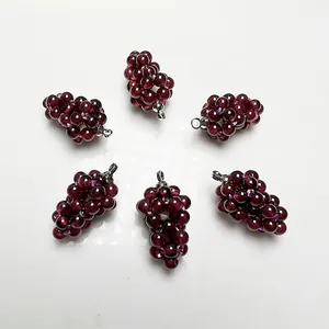 Detailed close-up of six handmade grape pendants made from dark red garnet beads