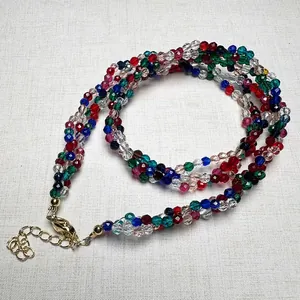 Macro shot of 3mm faceted spinel beads in multiple colors with gold lobster clasp