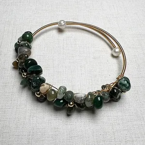 Handmade gold wire-wrapped cuff bracelet with green raw gemstones and white pearls