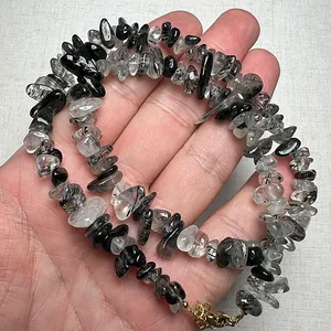Macro shot of natural black rutilated quartz and garnet stone chip beaded bracelet
