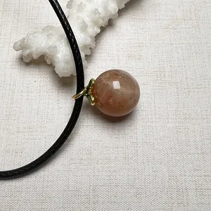 Minimalist sunstone energy crystal pendant necklace with golden metal clasp and black cord
