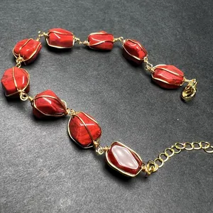 Detail of handmade wire-wrapped red gemstone bracelet with 14K gold filled adjustable chain