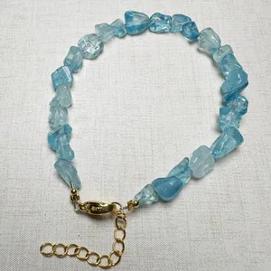 Close-up of irregular natural aquamarine crystal chip bracelet with golden lobster clasp