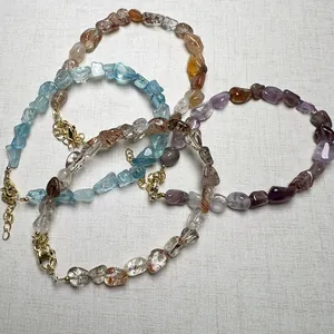 Macro view of natural crystal bracelets with raw aquamarine and amethyst stones