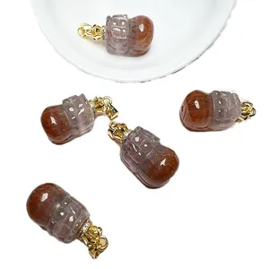 Peanut-shaped Auralite 23 crystal pendants with gold-plated crown clasps and zircons