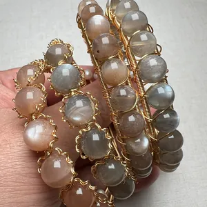 Close-up of handmade 14K gold wire wrapped bracelet with sunstone and moonstone beads