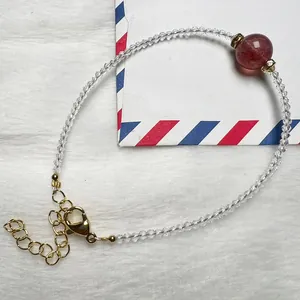 Handmade strawberry quartz bracelet with faceted white spinel beads and gold clasp