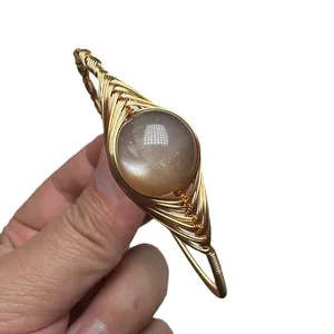 Handmade 14K gold wire wrapped bangle featuring a natural sunstone crystal gemstone