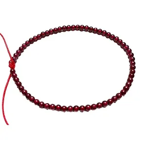 Adjustable garnet red beaded bracelet handcrafted with traditional woven cord