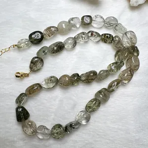 Dettaglio della collana di perle di cristallo fantasma verde naturale con chiusura dorata