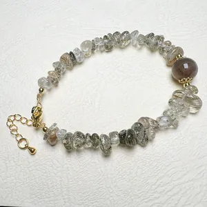 Detailed macro view of natural gemstone beads bracelet with gold-plated lobster clasp