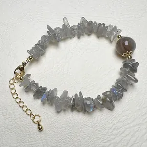 Macro detail of irregular grey labradorite beaded bracelet with gold lobster clasp