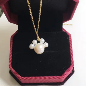 Detail of freshwater pearl cat paw pendant necklace in a red velvet jewelry gift box