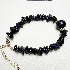 Macro shot of blue sandstone chip bracelet with gold adjustable clasp and main bead