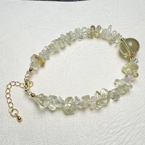 Detail of yellow natural crystal stone bracelet with gold plated clasp and extender chain