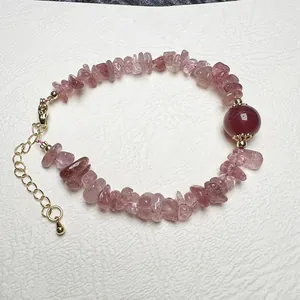 Close-up of pink strawberry quartz stone bracelet with gold lobster clasp and extension