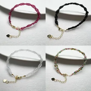 Detailed view of colorful spinels woven bracelets with 925 silver heart charms