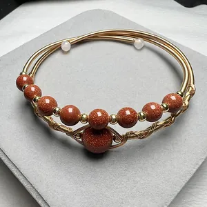 Handcrafted 14K gold filled layered wire bracelet with goldstone and cat-eye beads
